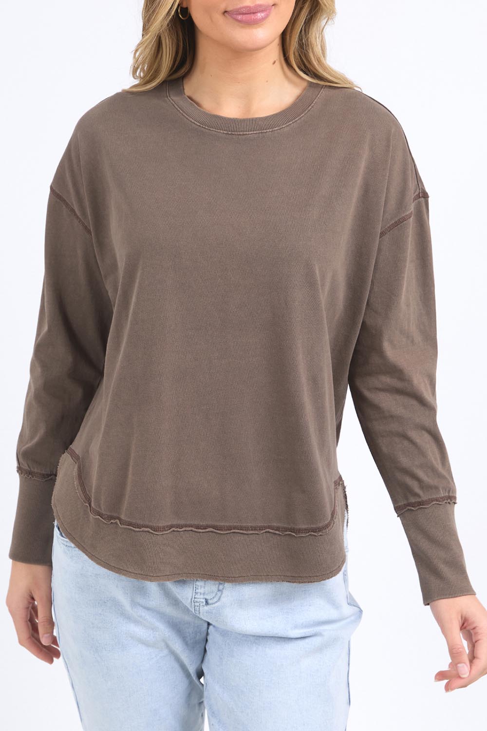 A model wearing the Elements Farrah Cotton Long Sleeve in colour Coffee, from the front, cropped image