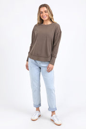 A model wearing the Elements Farrah Cotton Long Sleeve in colour Coffee, from the front, showing the whole outfit