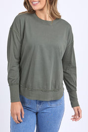A model wearing the Elements Farrah Cotton Long Sleeve in colour Khaki (Green), from the front, cropped image
