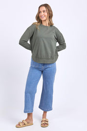A model wearing the Elements Farrah Cotton Long Sleeve in colour Khaki (Green), from the front, showing the whole outfit