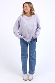 A model wearing the Effortless Cotton Crew in colour Pastelorch (Purple), from the front, showing the whole outfit