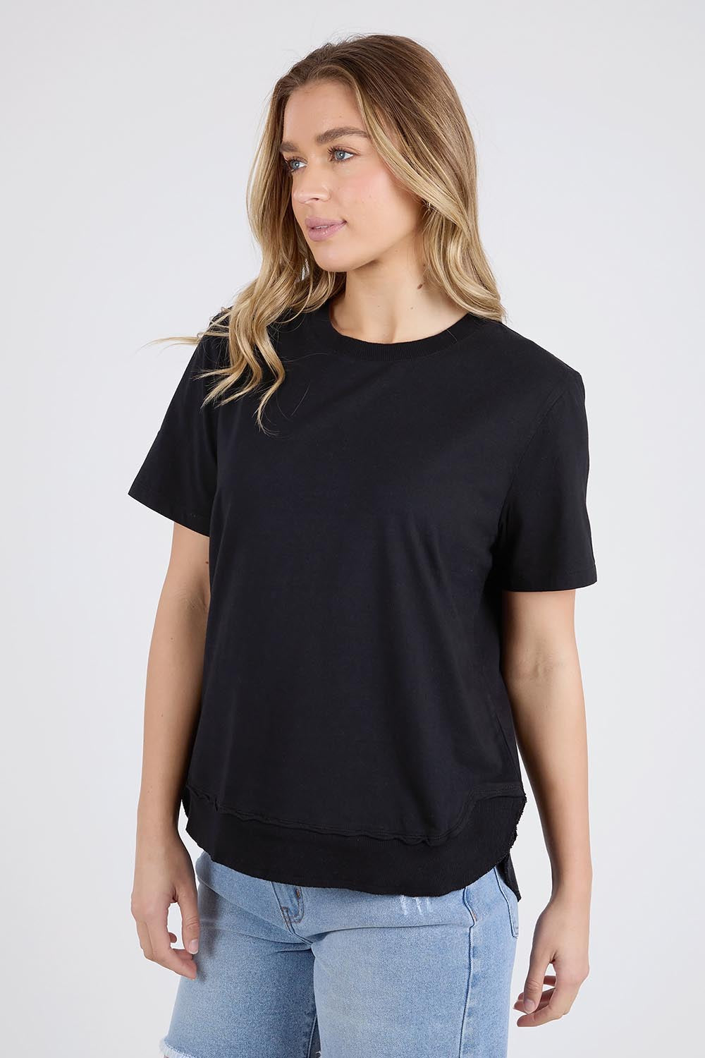 A model wearing the Elements Farrah Short Sleeve Cotton Tee in colour Black (Black), from the front, cropped image