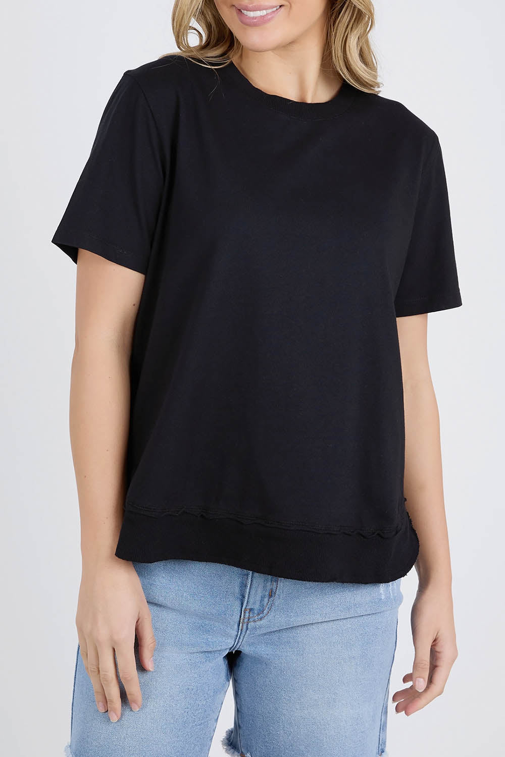 A model wearing the Elements Farrah Short Sleeve Cotton Tee in colour Black (Black), from the front, cropped image