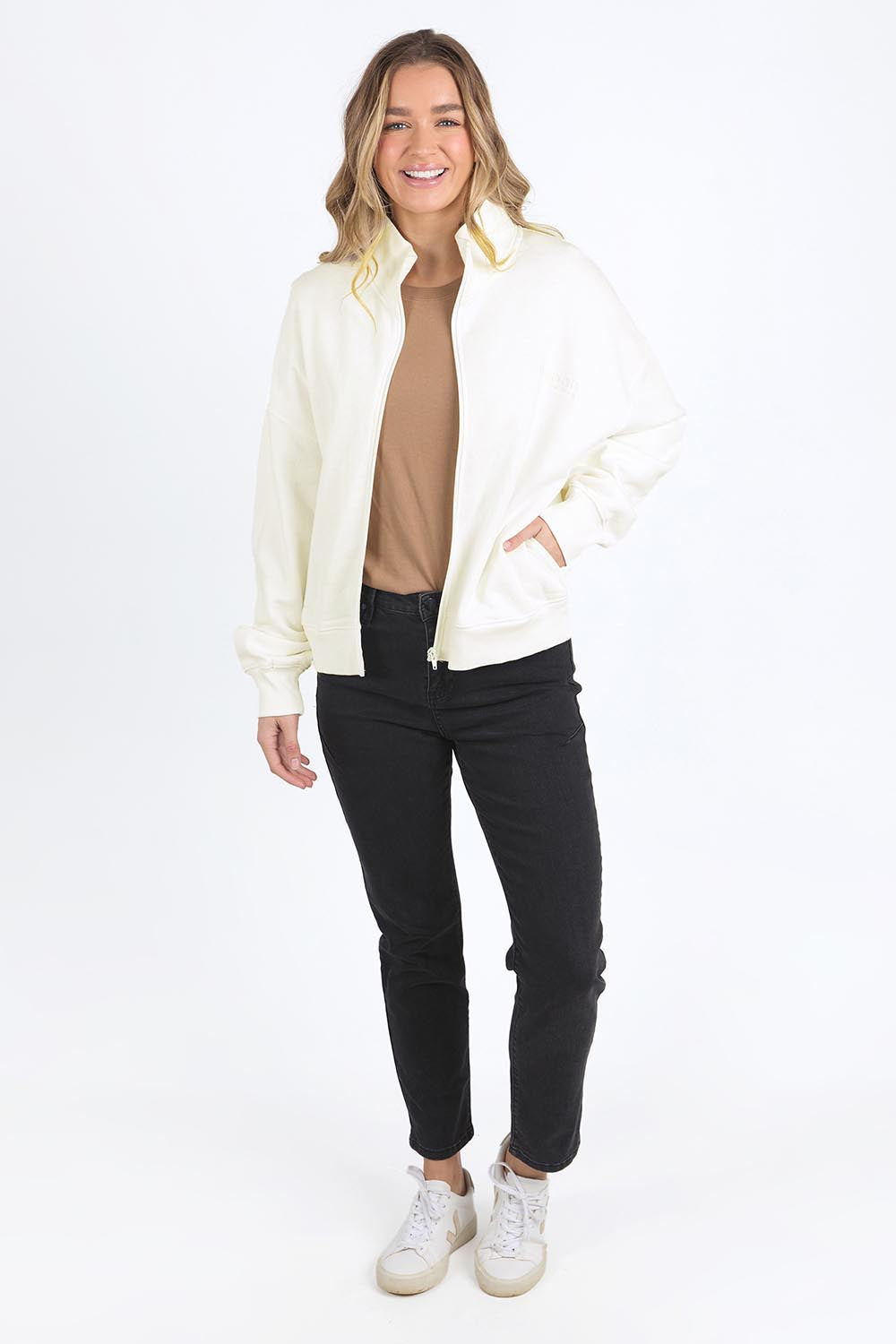 A model wearing the Elements Ember Zip Thru in colour White (White), from the front, showing the whole outfit