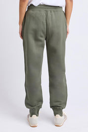 A model wearing the Elements Cotton College Track Pant in colour Khaki (Green), from the back