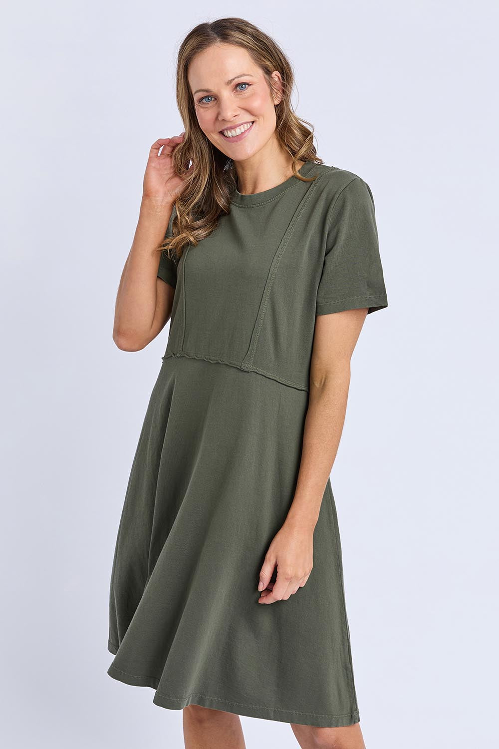 A model wearing the Elements Eva Cotton Dress in colour Khaki (Green), from the front, cropped image