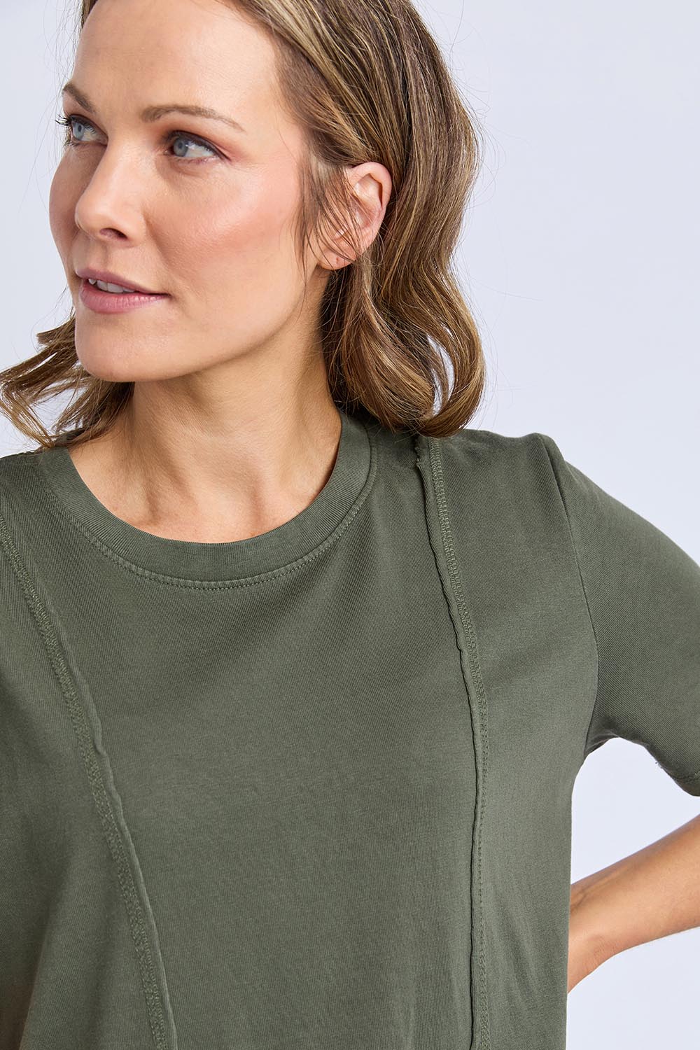 A model wearing the Elements Eva Cotton Dress in colour Khaki (Green), from the front, cropped image