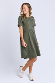 A model wearing the Elements Eva Cotton Dress in colour Khaki (Green), from the front, showing the whole outfit