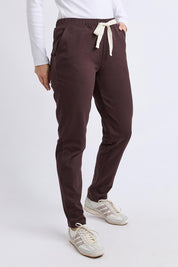 A model wearing the Elements Monday Cotton Pant in colour Coffee, from the front, cropped image