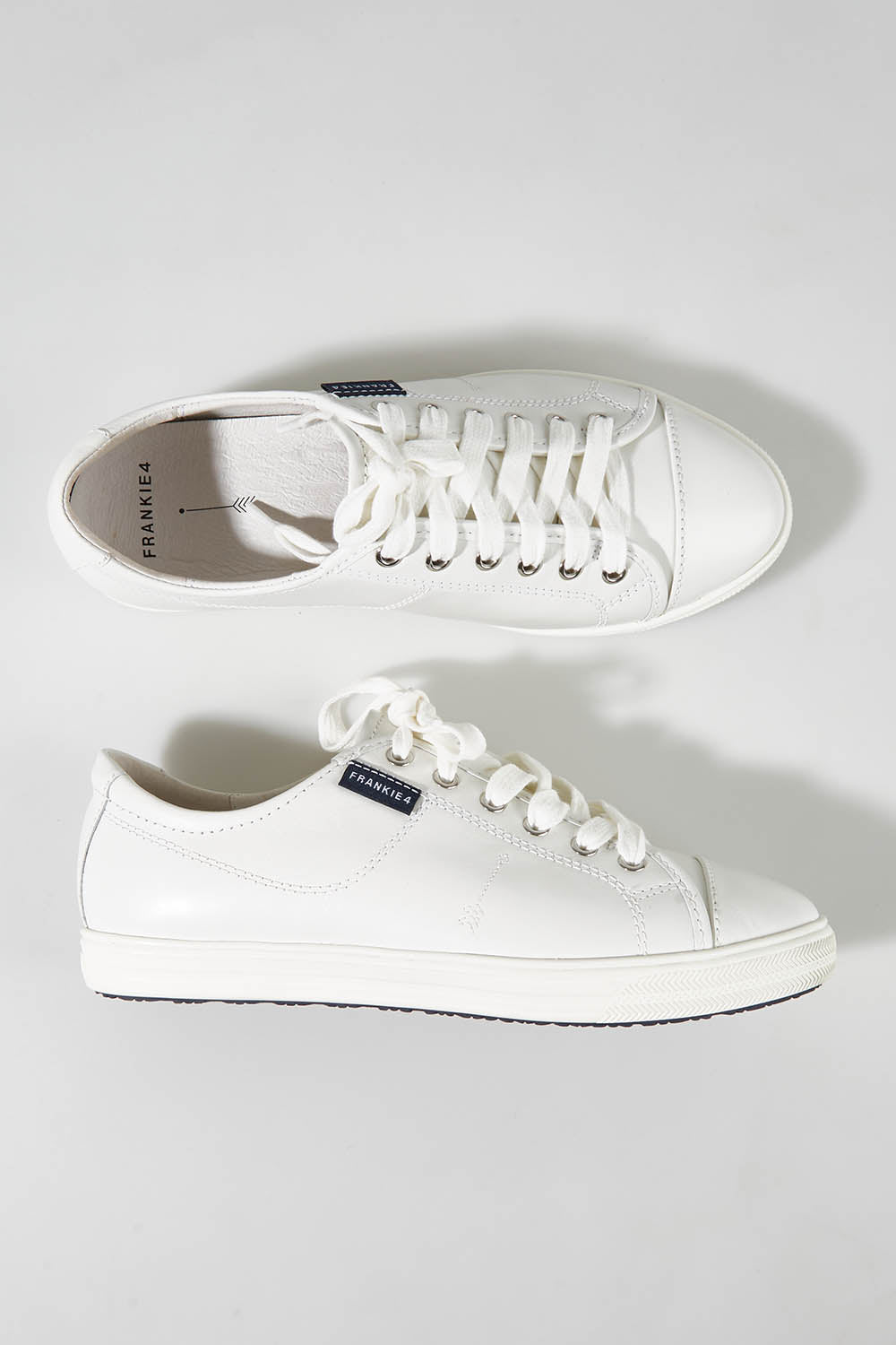 A model wearing size 7 of the Nat Leather Sneaker in colour White (White), from the front, showing the whole outfit
