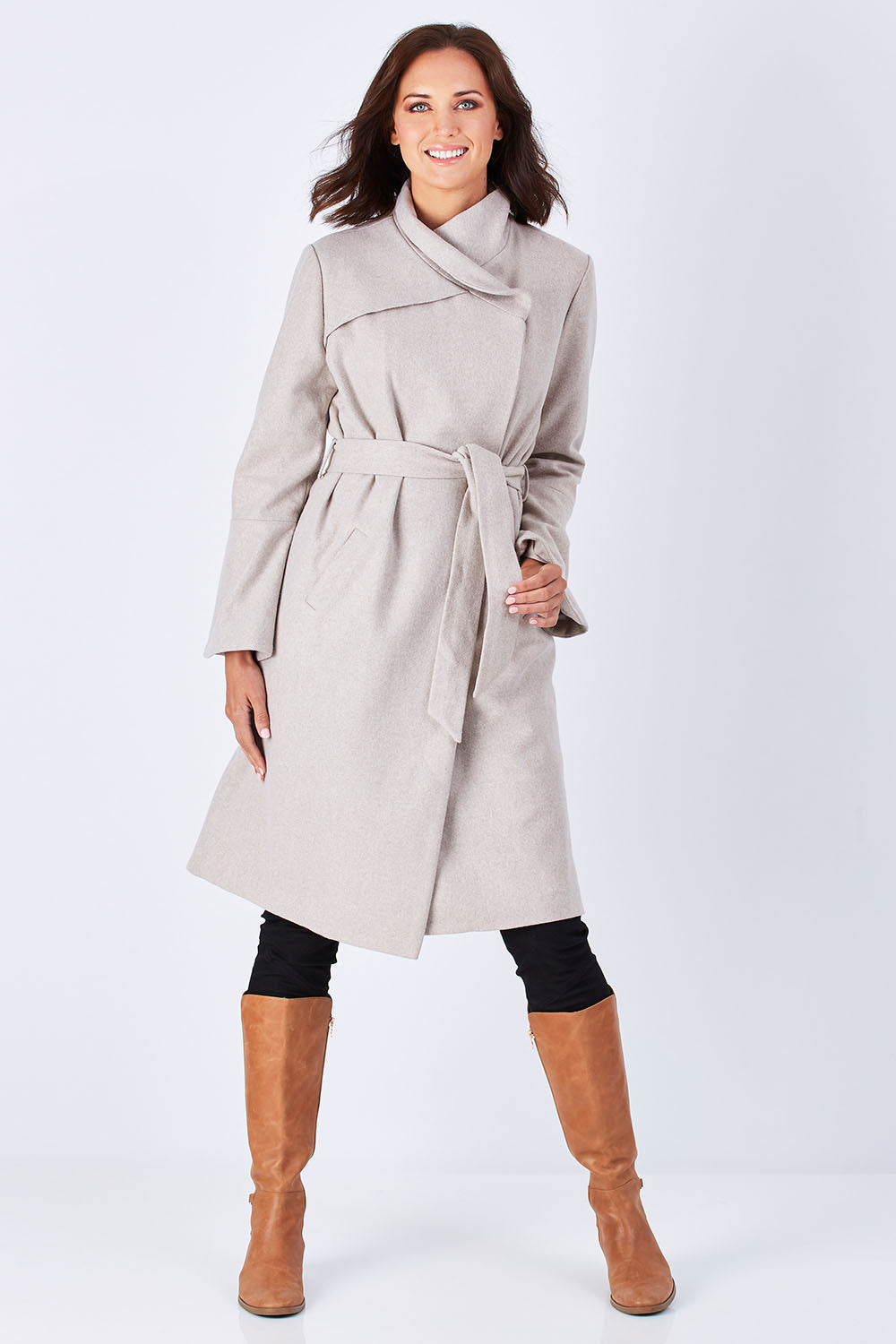 Model Perrie wearing size 10 of the Maniaa Long Coat in colour Chestnut, from the front, showing the whole outfit