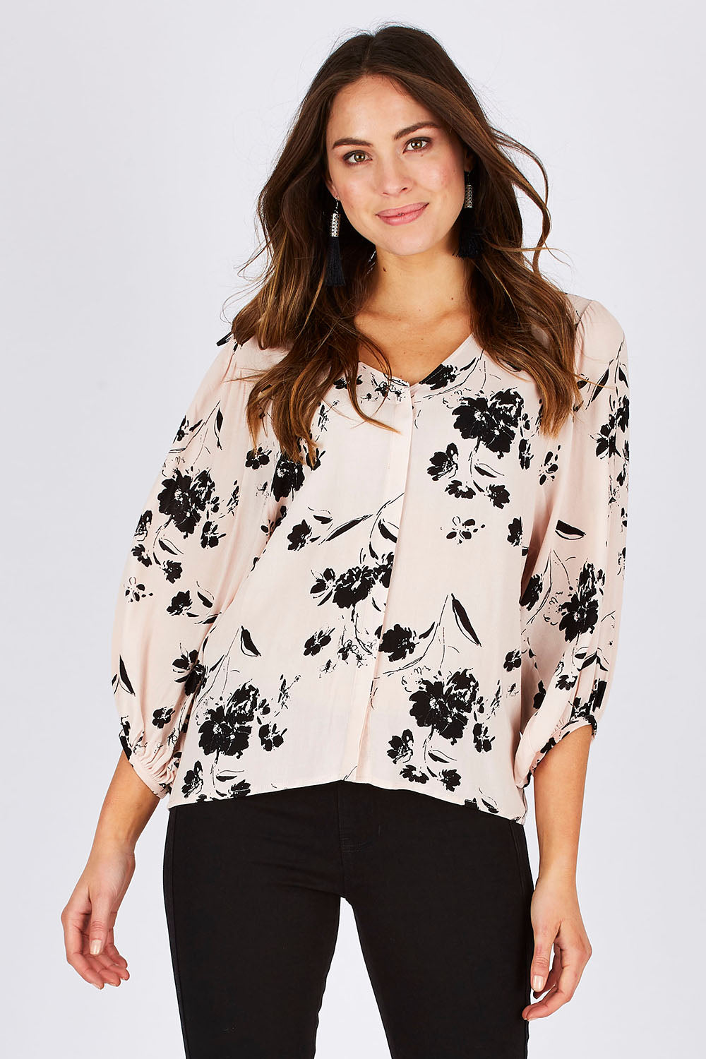 Model Madeline wearing size 10 of the Dream Big Blouse in colour DreamBigBl (Pink), from the front, cropped image