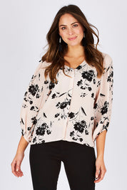 Model Madeline wearing size 10 of the Dream Big Blouse in colour DreamBigBl (Pink), from the front, cropped image