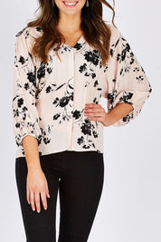 Model Madeline wearing size 10 of the Dream Big Blouse in colour DreamBigBl (Pink), from the front, cropped image
