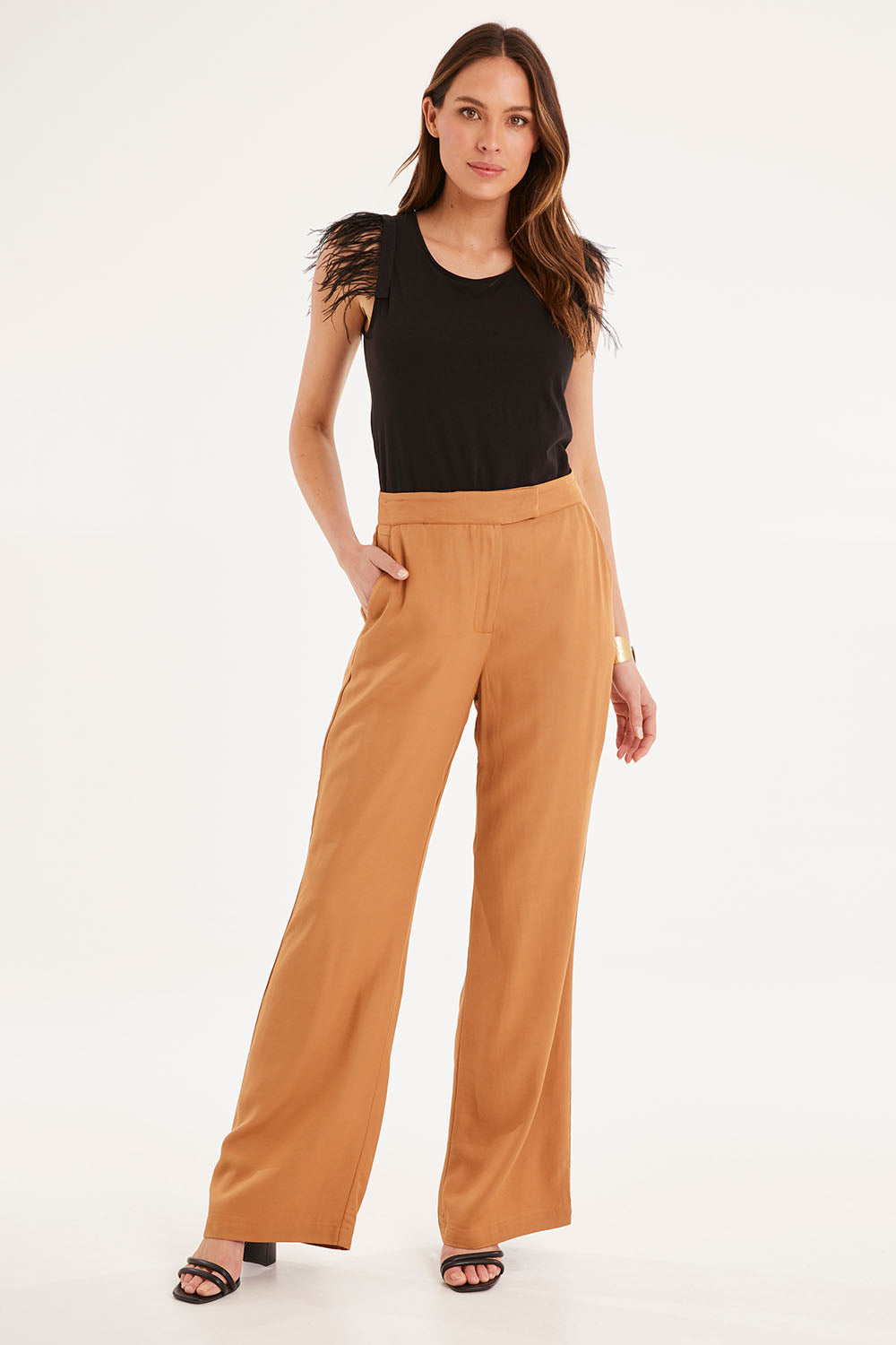 Model Madeline wearing size 10 of the Heart & Soul Flare Pant in colour Caramel, from the front, showing the whole outfit