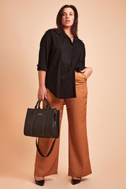 Model Poppy wearing size 16 of the Heart & Soul Flare Pant in colour Caramel, from the front, showing the whole outfit