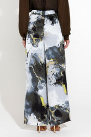 A model wearing the Transfixed Wide Leg Pant in colour Marble (Black), from the back
