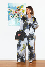 A model wearing the Transfixed Wide Leg Pant in colour Marble (Black), from the front, showing the whole outfit