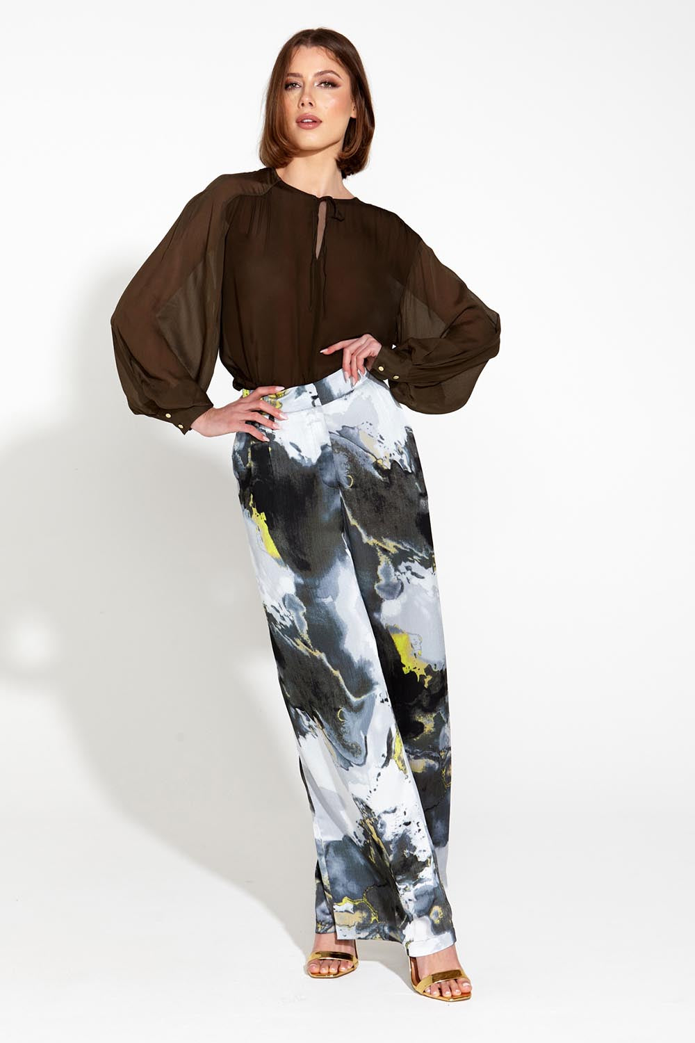 A model wearing the Transfixed Wide Leg Pant in colour Marble (Black), from the front, showing the whole outfit