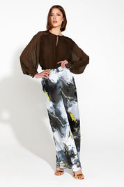 A model wearing the Transfixed Wide Leg Pant in colour Marble (Black), from the front, showing the whole outfit