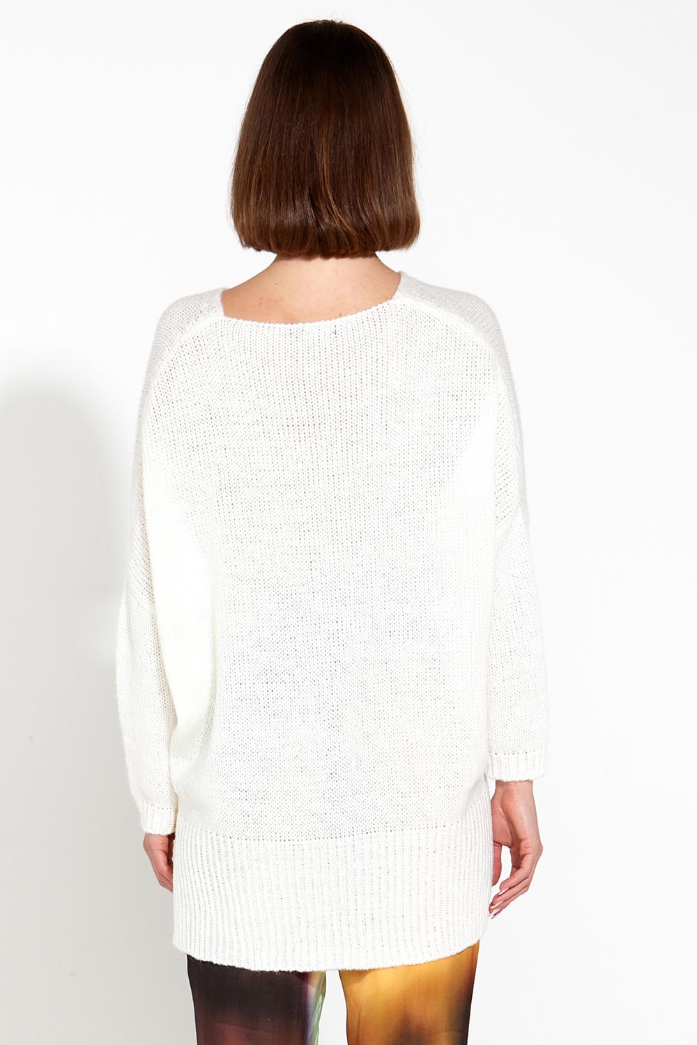 A model wearing the Splendour Oversized Knit in colour Cream (White), from the back