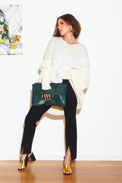 A model wearing the Splendour Oversized Knit in colour Cream (White), from the front, showing the whole outfit