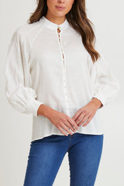 Model Madeline wearing size 10 of the Berry Kiss Linen Tencel Blend Blouse in colour Ivory (White), from the front, cropped image