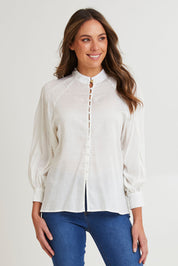 Model Madeline wearing size 10 of the Berry Kiss Linen Tencel Blend Blouse in colour Ivory (White), from the front, cropped image