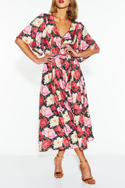 A model wearing the Lyrical Lyocell Midi Dress in colour Oscarflora (Pink), from the front, cropped image