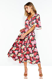A model wearing the Lyrical Lyocell Midi Dress in colour Oscarflora (Pink), from the front, showing the whole outfit
