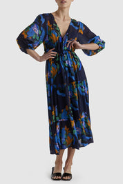 A model wearing the Twilight Dress in colour Navyfloral (Blue), from the front, cropped image