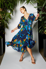 A model wearing the Twilight Dress in colour Navyfloral (Blue), from the front, showing the whole outfit