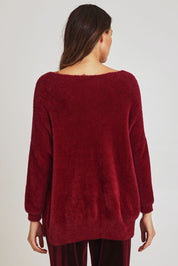Model Madeline wearing size 10 of the Electra Knit in colour Wine (Red), from the back