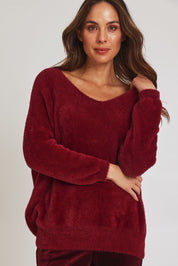 Model Madeline wearing size 10 of the Electra Knit in colour Wine (Red), from the front, cropped image