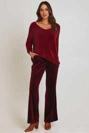 Model Madeline wearing size 10 of the Electra Knit in colour Wine (Red), from the front, showing the whole outfit