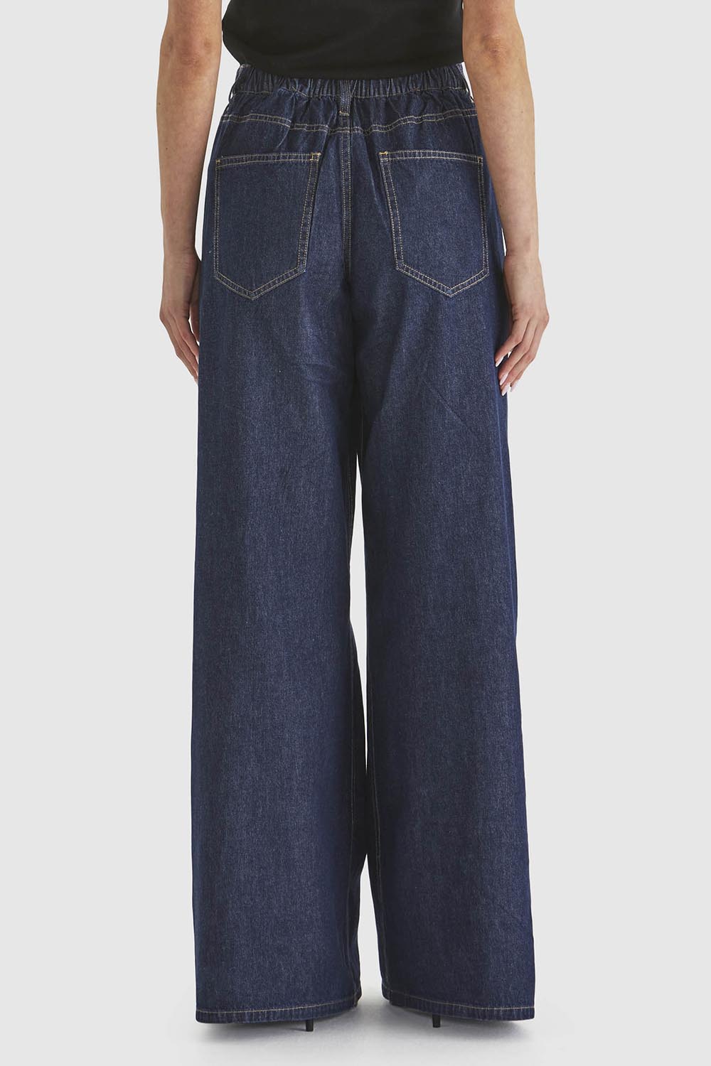 A model wearing the Soaring Denim Jean in colour Indigo (Blue), from the back