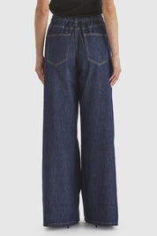 A model wearing the Soaring Denim Jean in colour Indigo (Blue), from the back