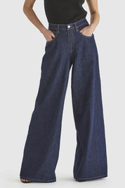 A model wearing the Soaring Denim Jean in colour Indigo (Blue), from the front, cropped image