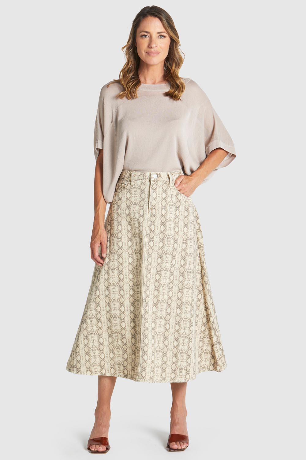 A model wearing the Chameleon Denim Skirt in colour Snakeskin, from the front, showing the whole outfit