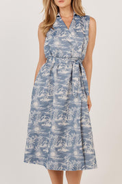 A model wearing the Zanzabar Dress in colour Bluereed (Blue), from the front, cropped image