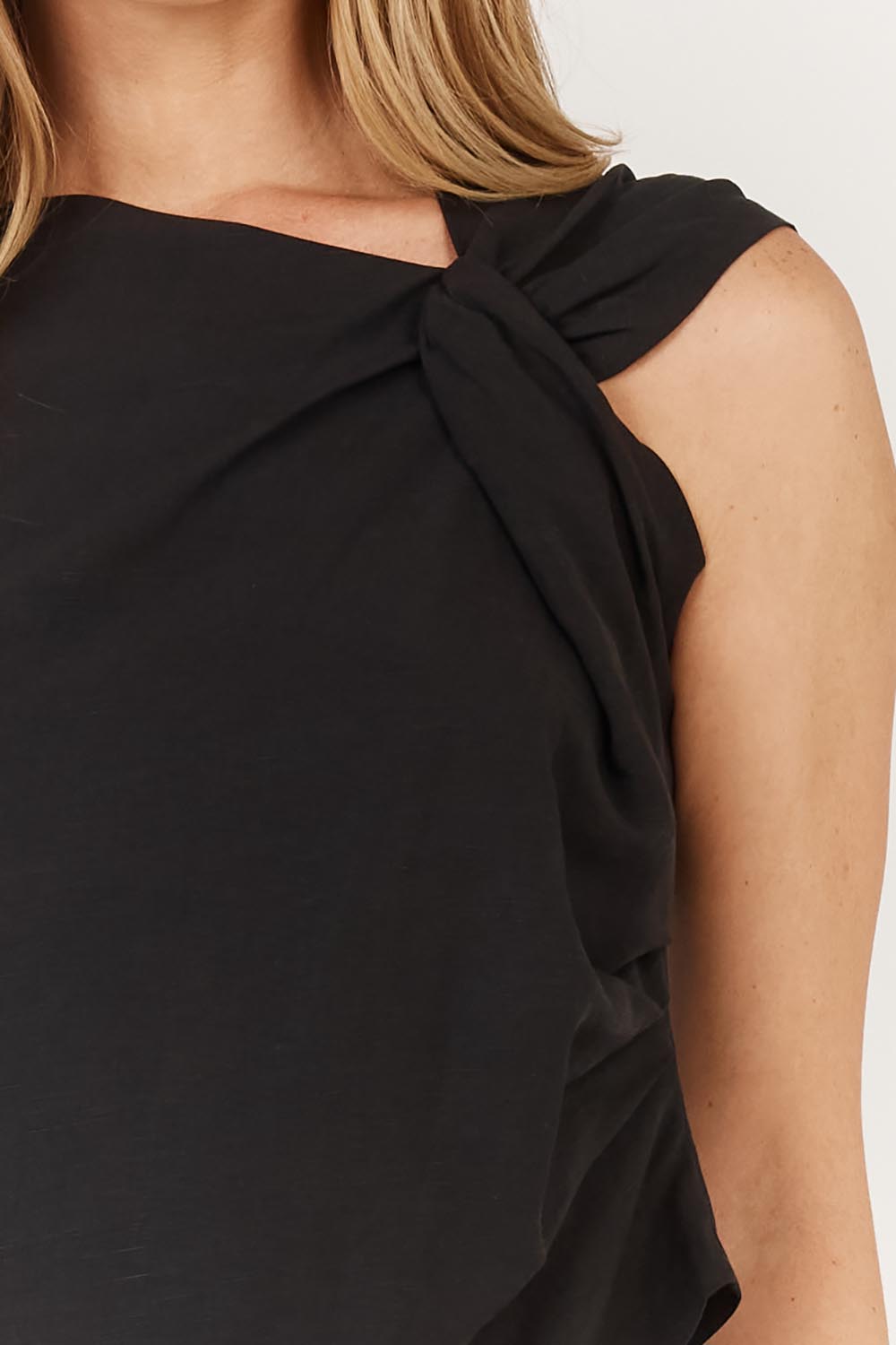 A model wearing the Sandara Top in colour Black (Black), from the front, cropped image