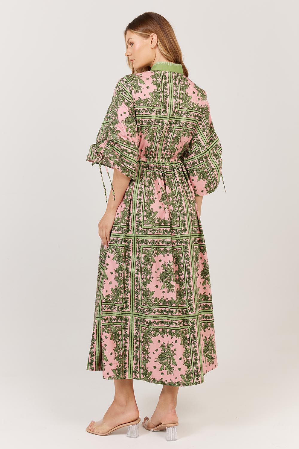 A model wearing the Dominica Cotton Dress in colour Paisley (Green), from the back