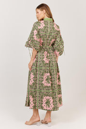 A model wearing the Dominica Cotton Dress in colour Paisley (Green), from the back