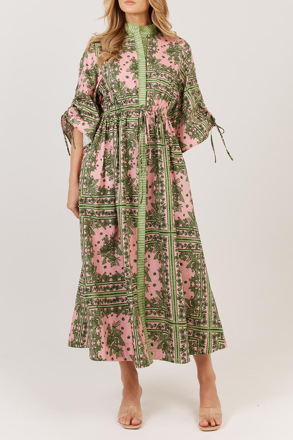 A model wearing the Dominica Cotton Dress in colour Paisley (Green), from the front, cropped image