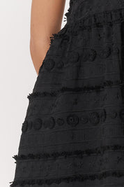 A model wearing the Sierra Lyocell Blend Lace Dress in colour Black (Black), from the front, cropped image