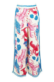 Product shot of the Soleil Pant in colour Lobster, from the back