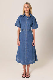A model wearing the Sloane Embroidered Denim Dress in colour Midblue (Blue), from the front, showing the whole outfit