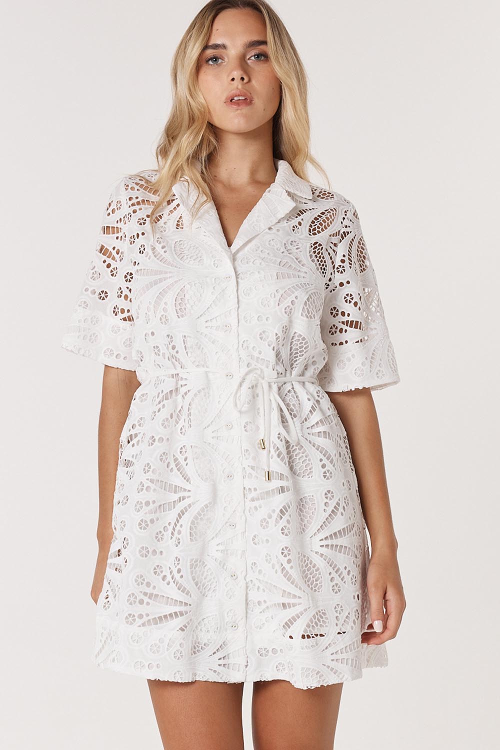 A model wearing the Elara Broderie Shirt Dress in colour Ivory (White), from the front, cropped image