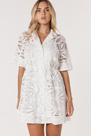 A model wearing the Elara Broderie Shirt Dress in colour Ivory (White), from the front, cropped image