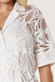 A model wearing the Elara Broderie Shirt Dress in colour Ivory (White), from the front, cropped image